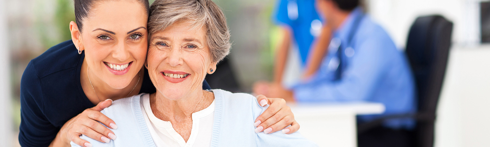 Resident and staff member sharing a happy moment.