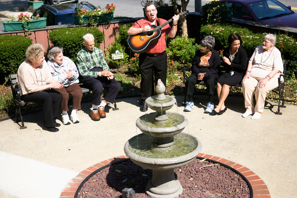 Residents enjoying music by the fountain outdoors.