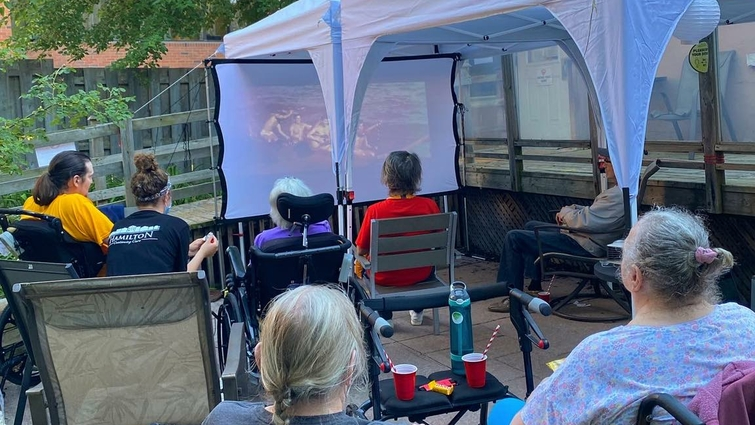 Residents enjoying an outdoor movie screening.
