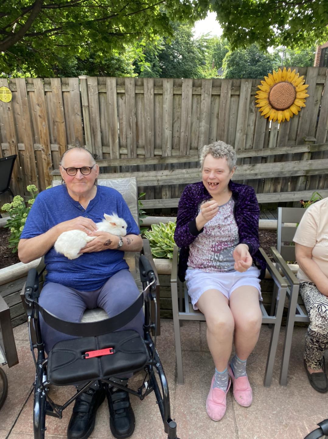 Residents enjoying time outdoors with a rabbit