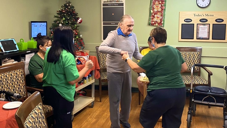 Residents and staff engaging in a joyful activity.