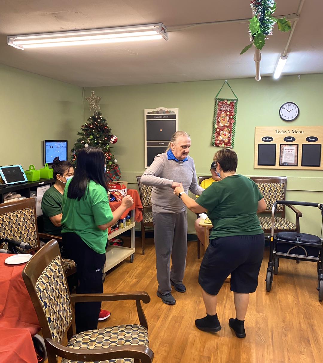 Residents and staff celebrating with a Christmas tree