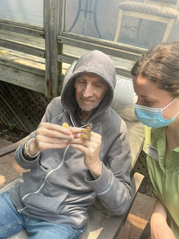 Resident enjoying time outdoors with staff member.