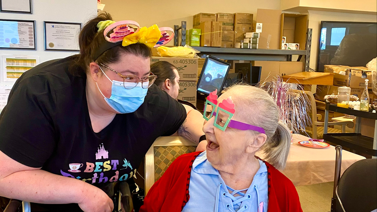Resident and staff celebrating a birthday together