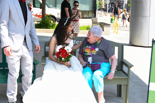 A resident chatting with a bride outdoors.
