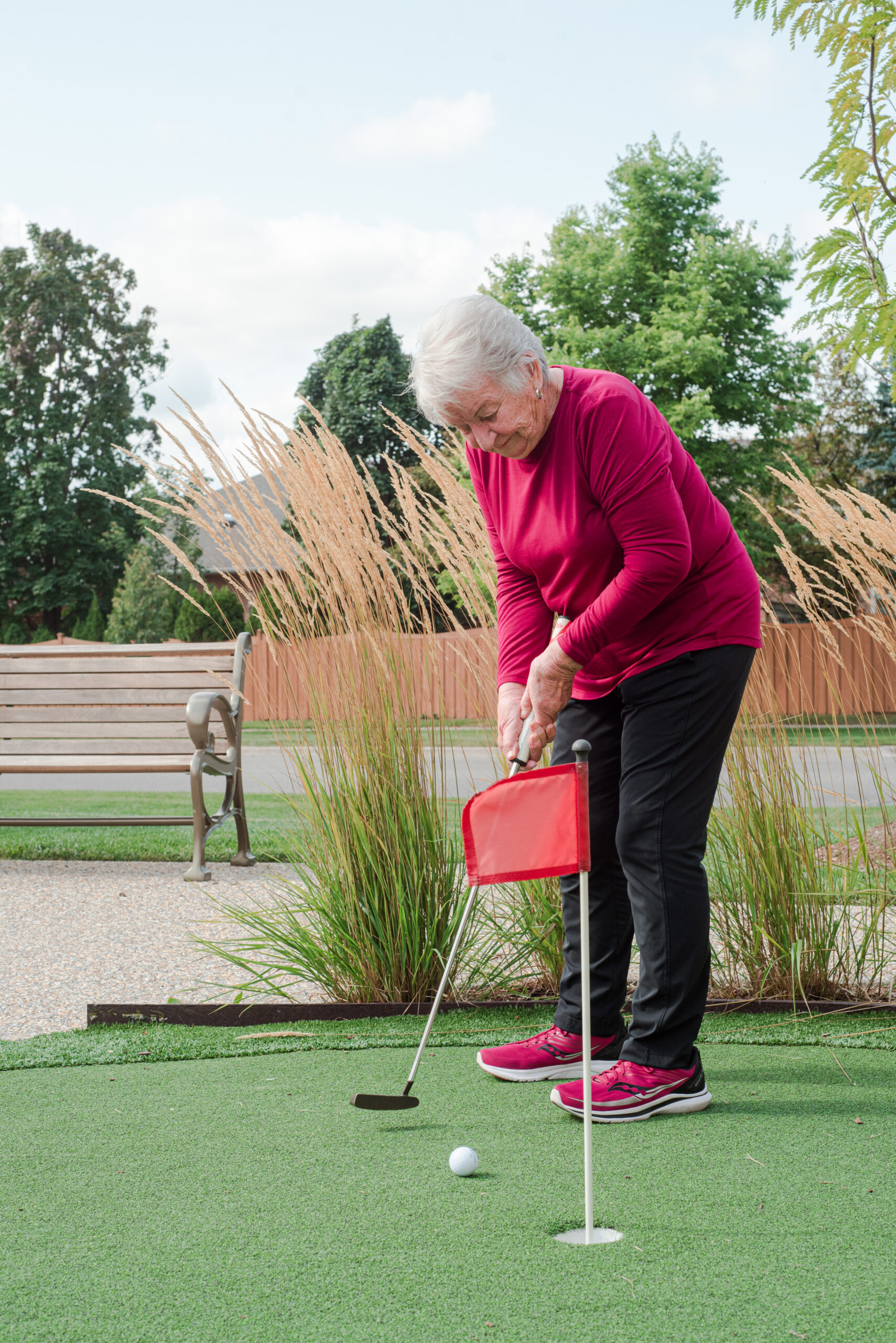 Senior woman practicing golf in outdoor space
