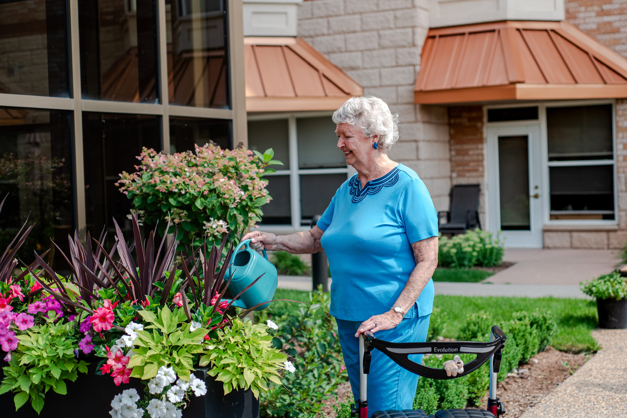 Resident gardening with a watering can outdoors.