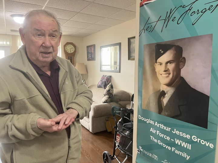 Resident sharing memories by a banner.