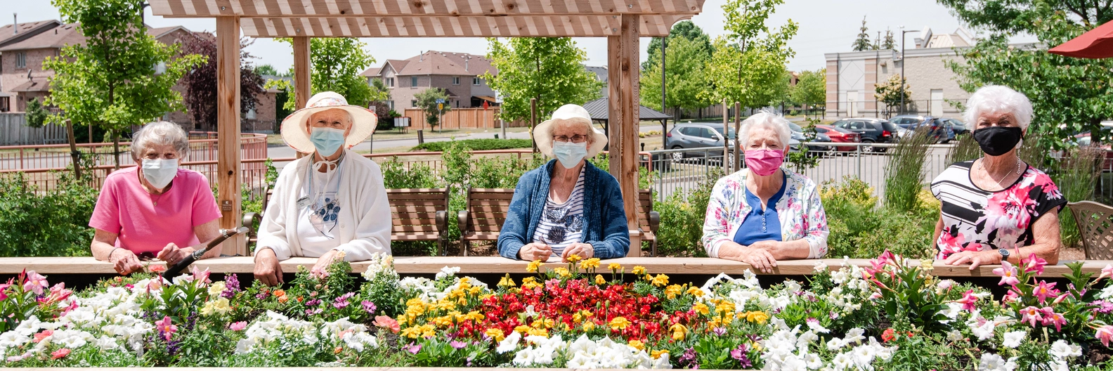 Five residents enjoying the garden space together.