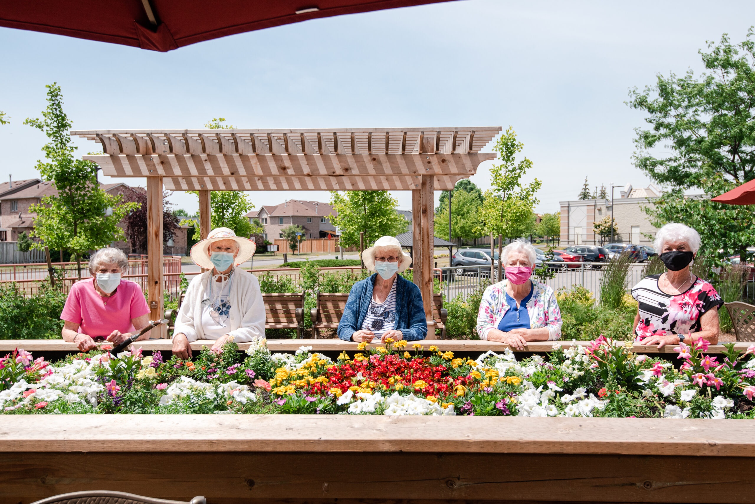 Residents enjoying flowers in an outdoor space.