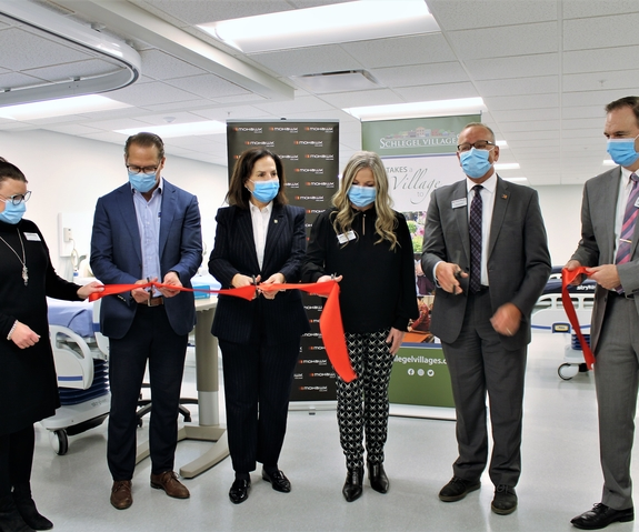 Ribbon-cutting ceremony with staff members