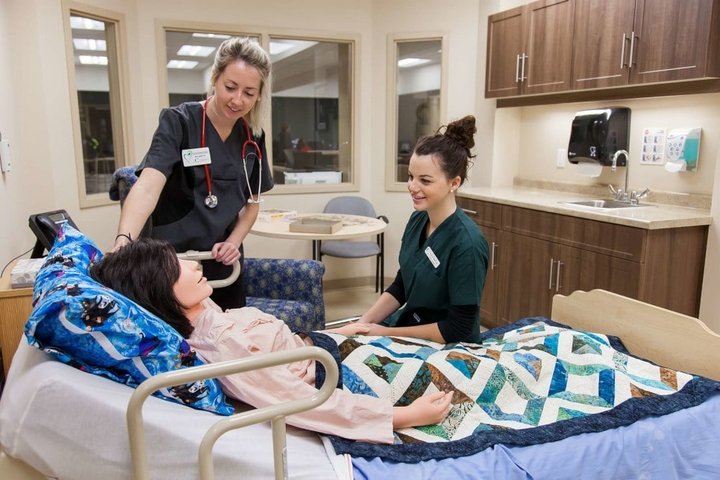Nursing staff interacting with a patient mannequin