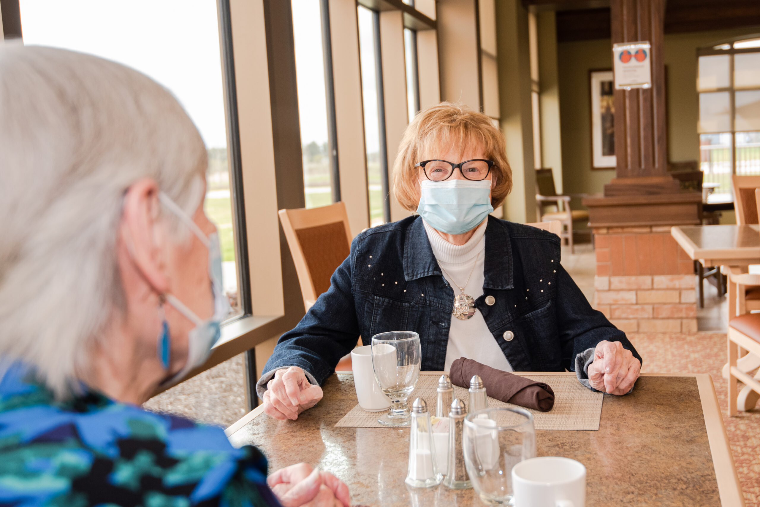 Residents enjoying conversations in a dining area