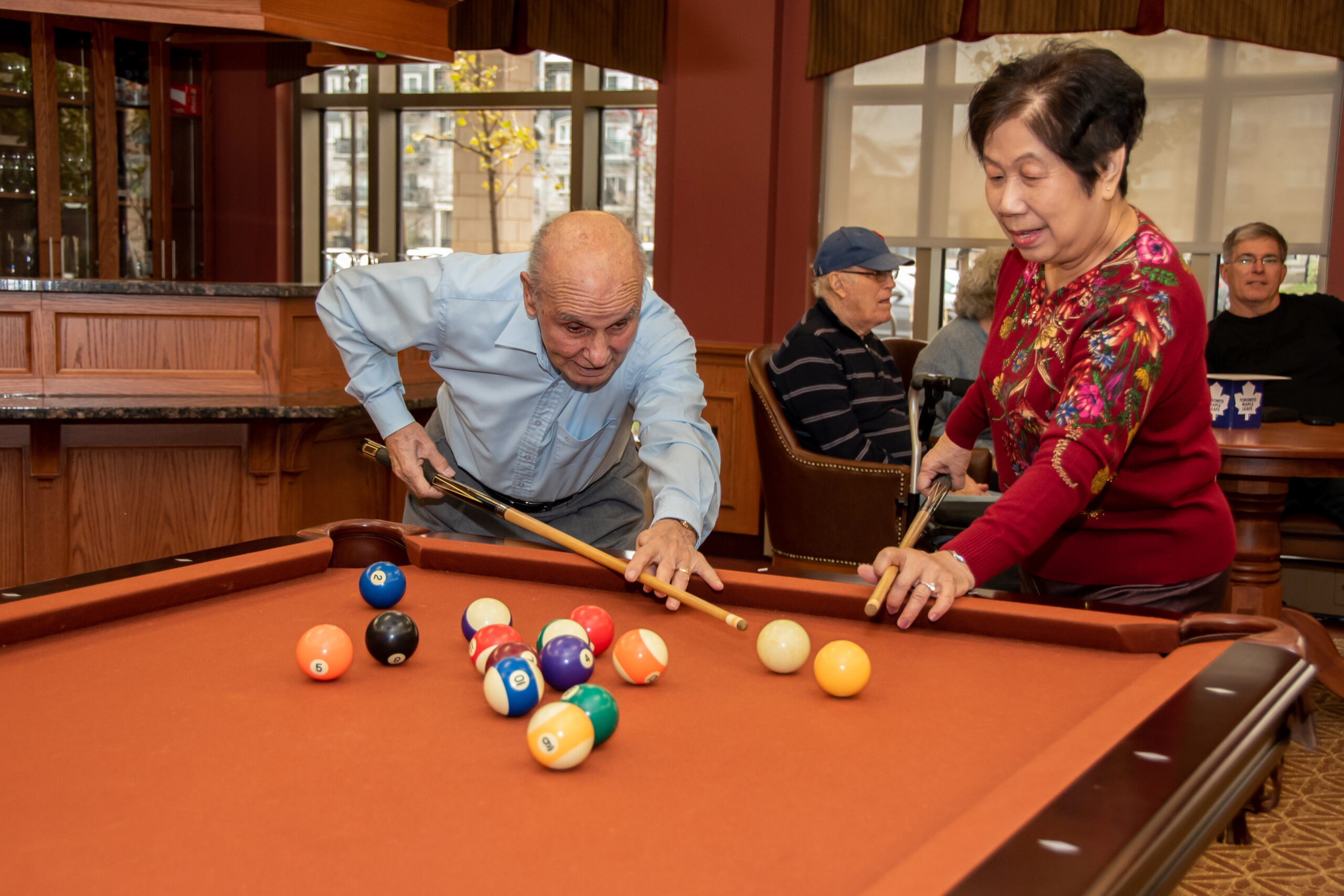 Residents playing pool in a communal area.