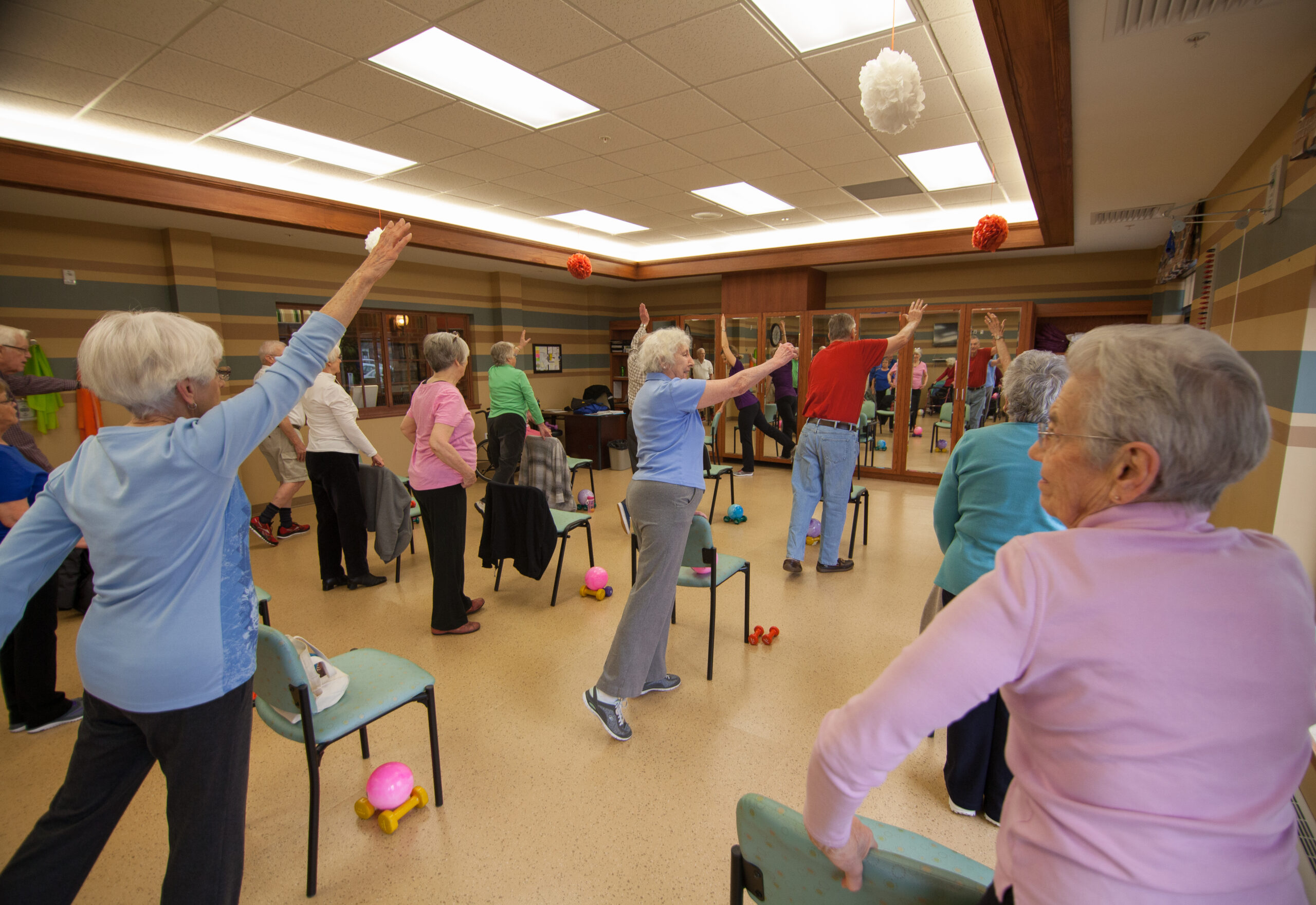 Seniors participating in an exercise class indoors.