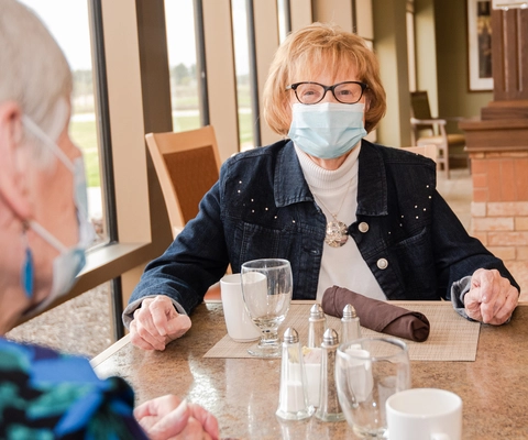 Residents enjoying a meal in the dining area.