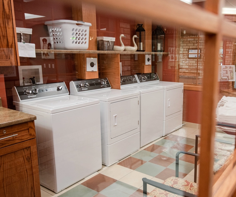 Laundry area with washing machines and dryer