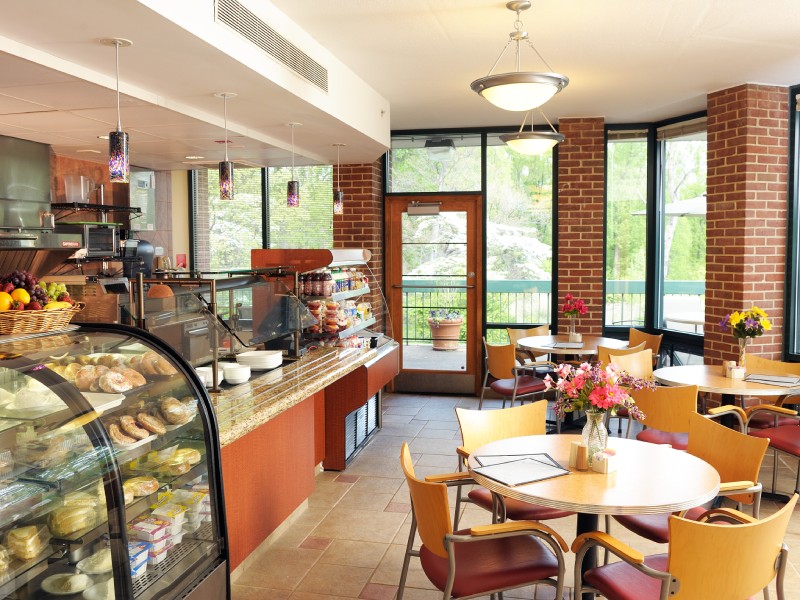 Bright dining area with tables and pastries