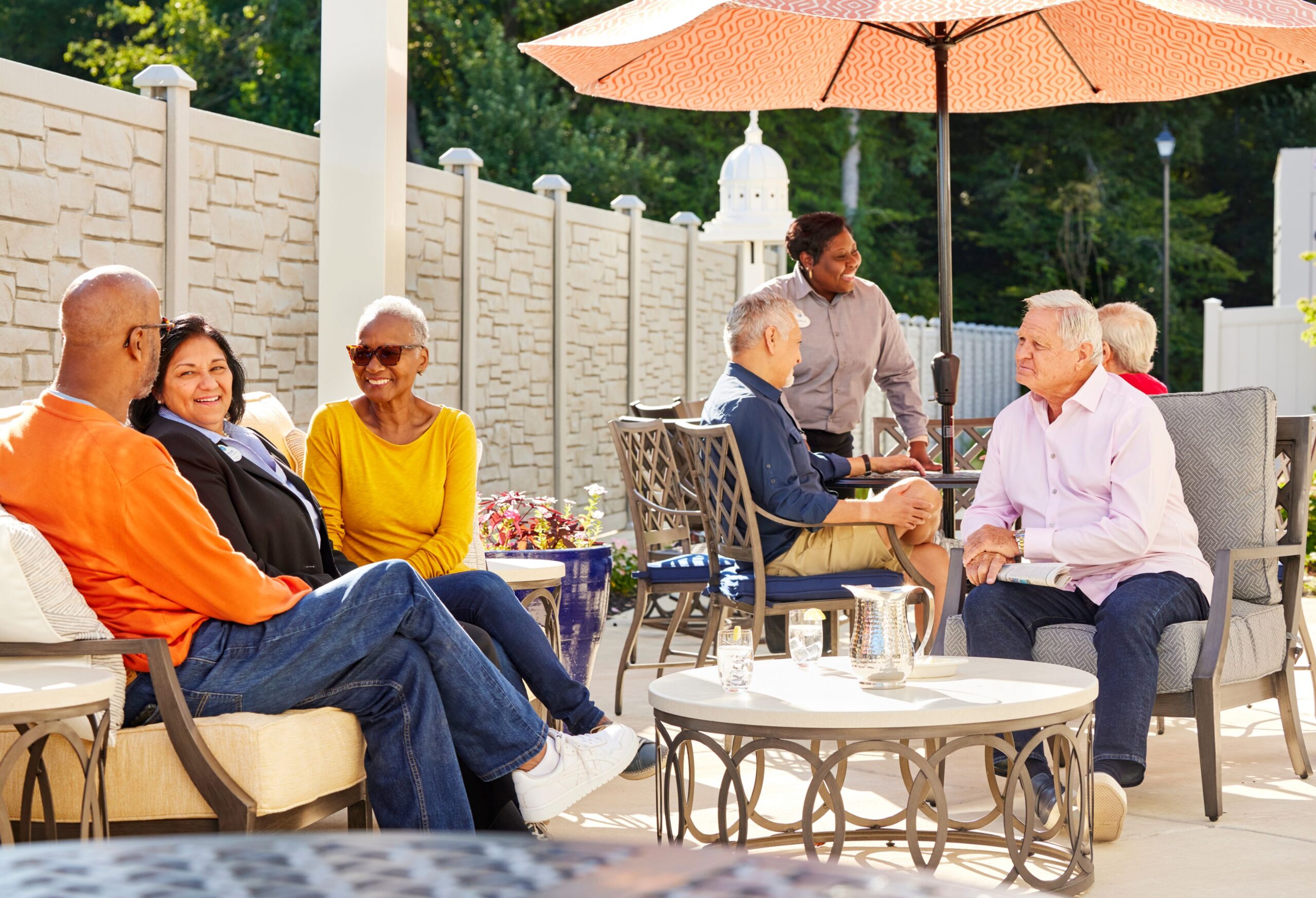 Residents enjoying time outdoors on a sunny patio