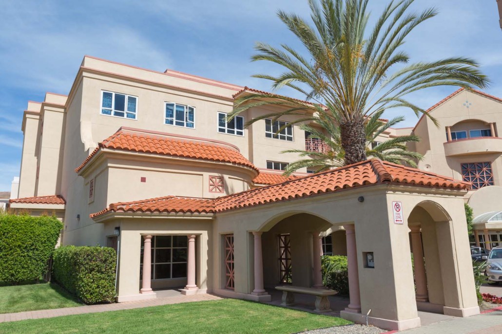 Exterior view of the facility with palm trees