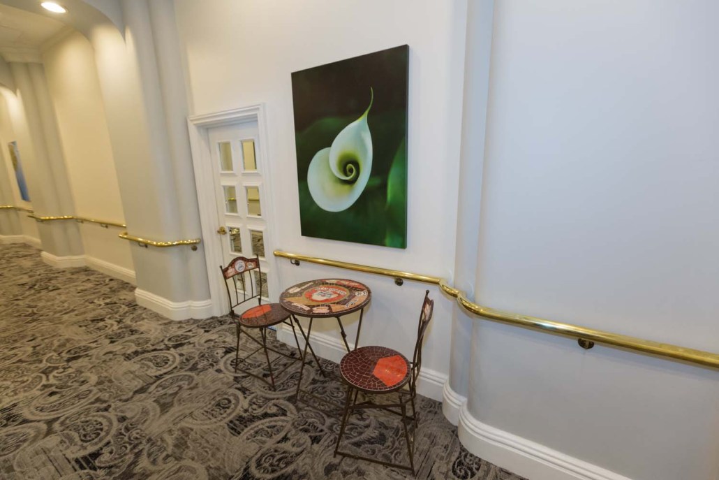 Artwork and seating area in a hallway