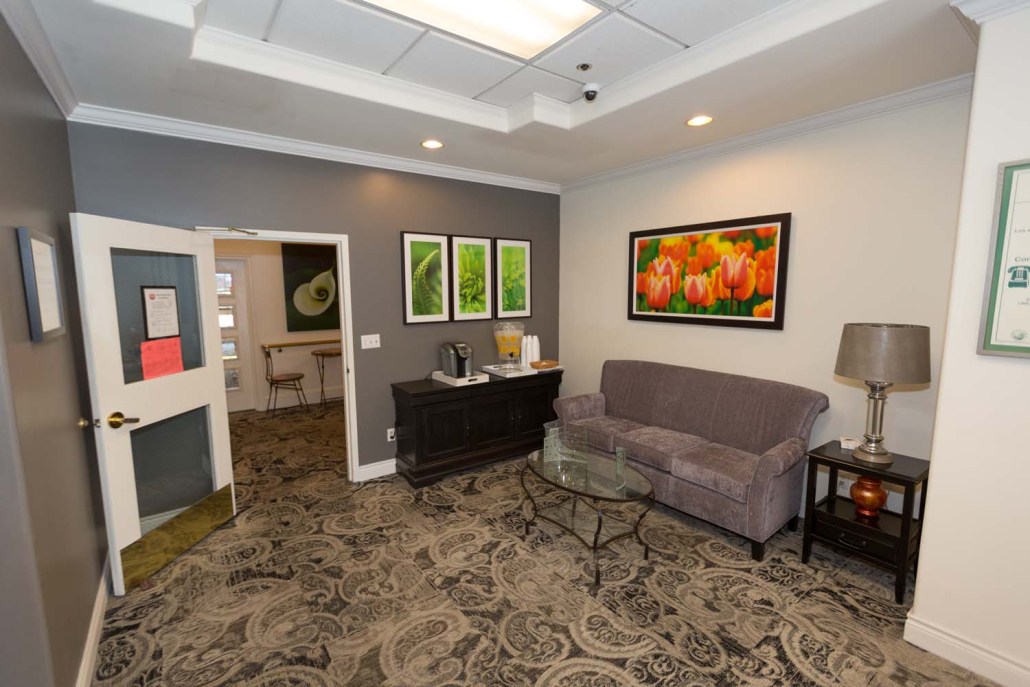 Lounge area with seating and floral artwork.
