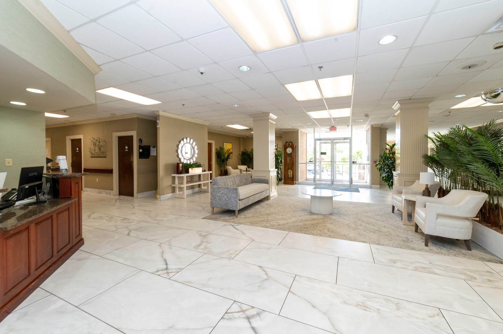 Bright and inviting common area with seating and plants.