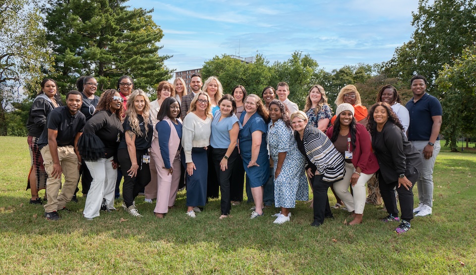 Group of smiling staff members in a park