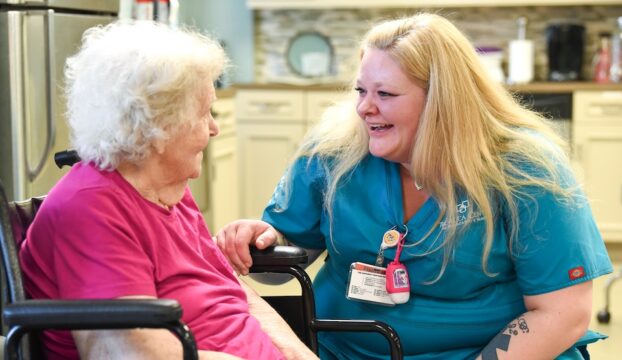 Caregiver interacting joyfully with a resident