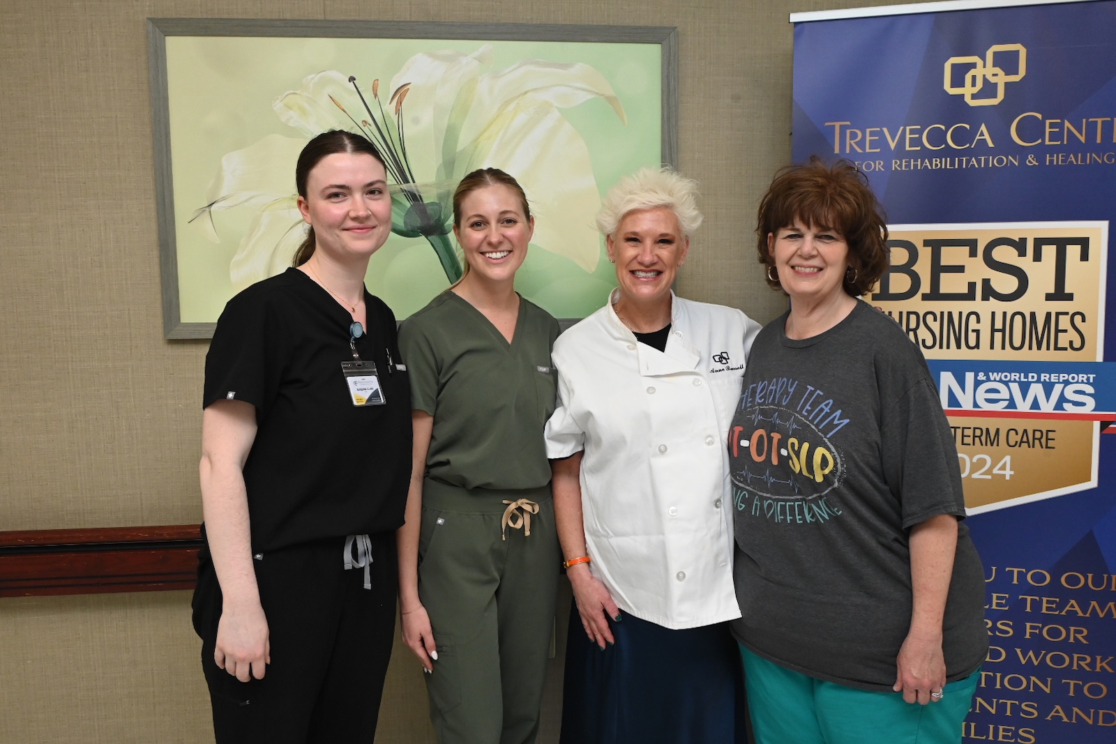 Staff members smiling together at an event