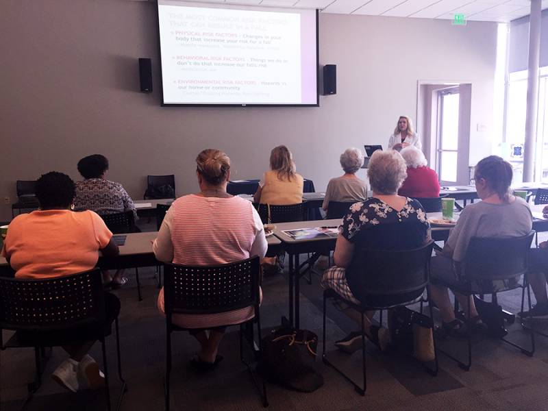Residents attending a wellness workshop in a bright room.