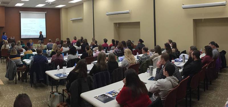 Large group meeting in a facility interior space.