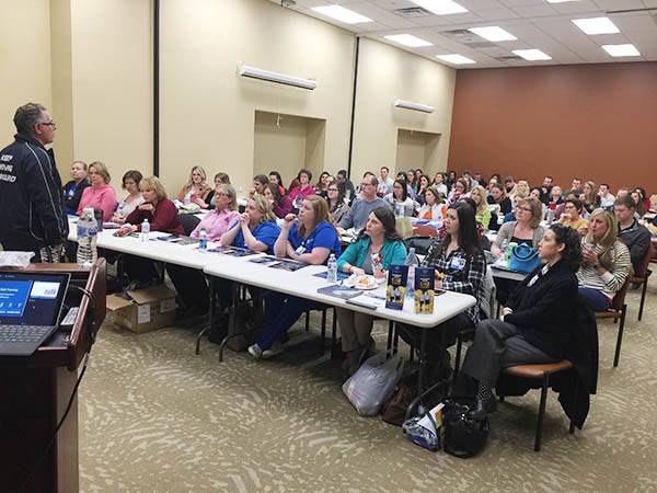 Large meeting with staff members in attendance.