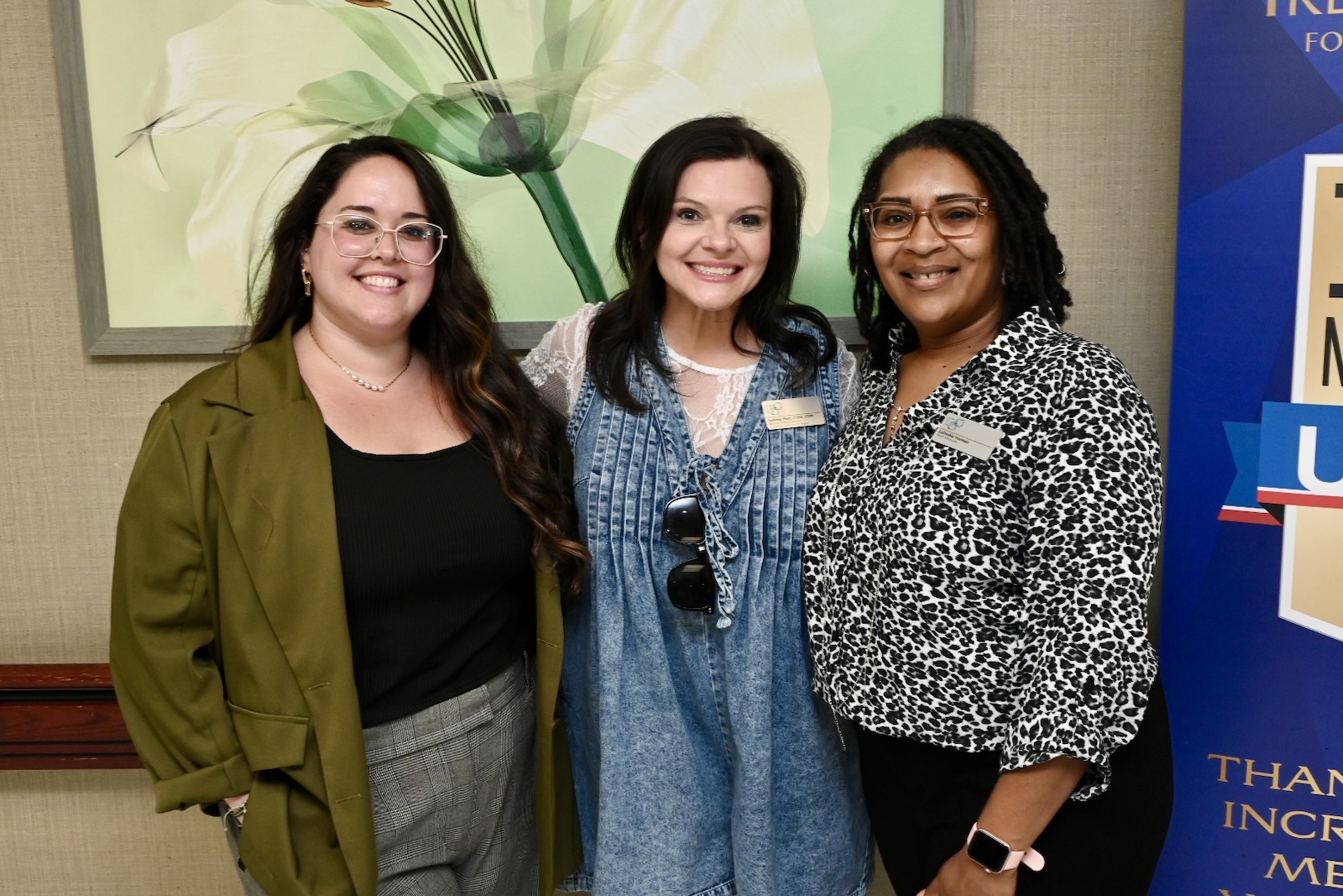 Three staff members smiling together