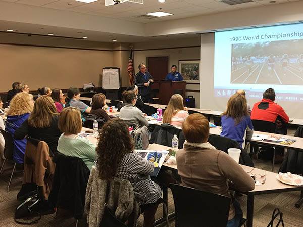 Group of people attending a presentation in a conference room.