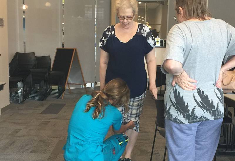Staff assisting a resident in a common area.