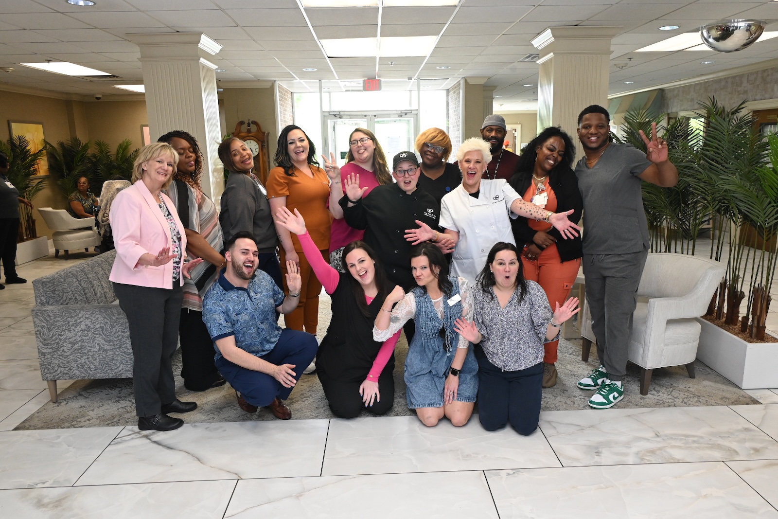 Staff and residents happily posing together