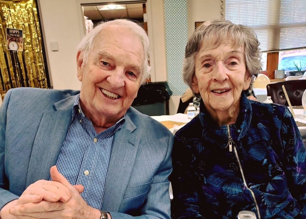 Happy elderly couple in a social setting.