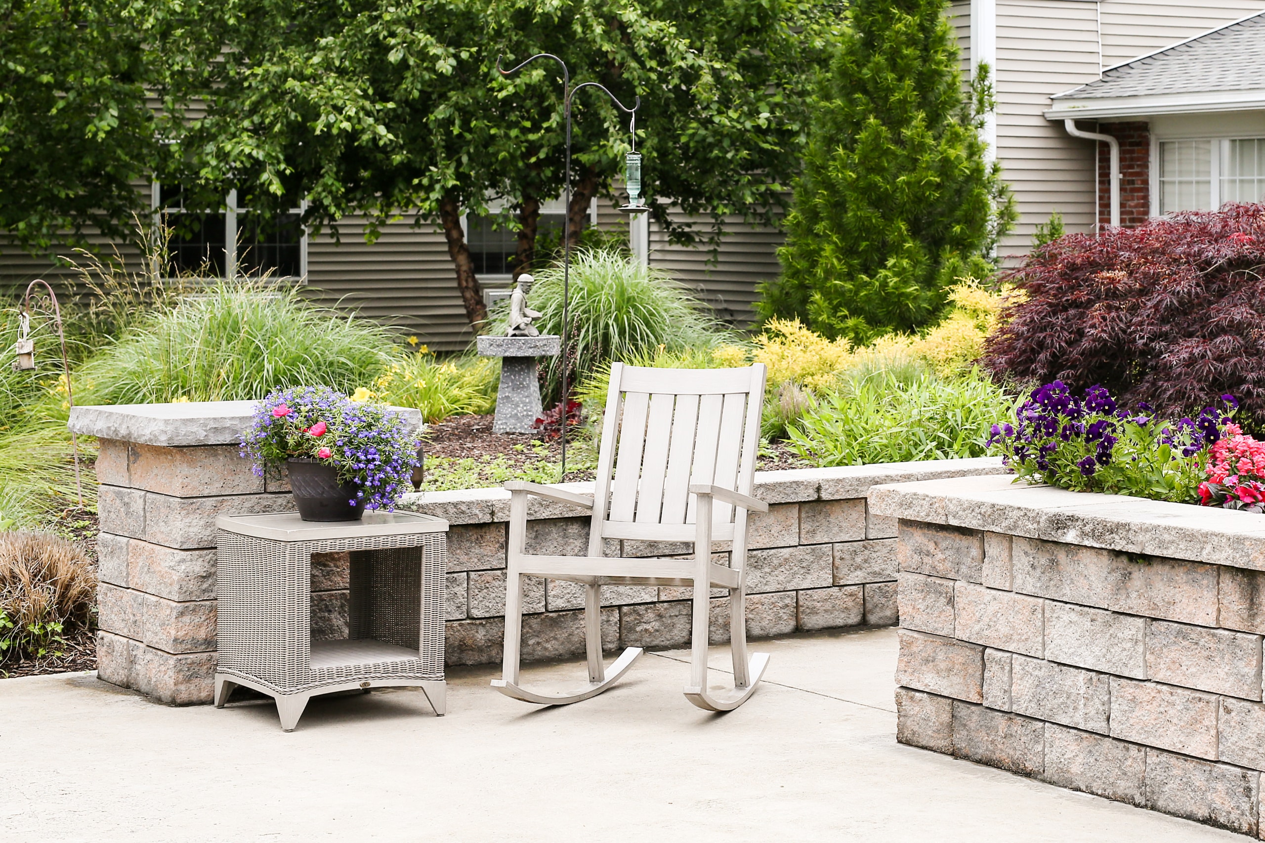 Outdoor seating area with flowers and greenery