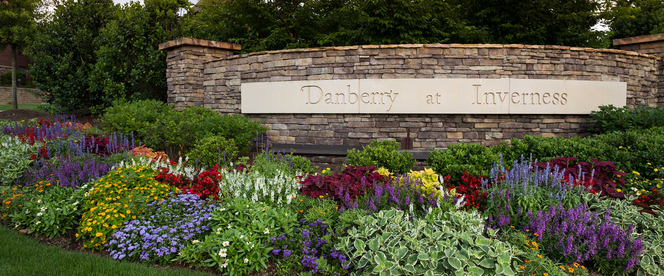 Outdoor view of the facility sign surrounded by flowers
