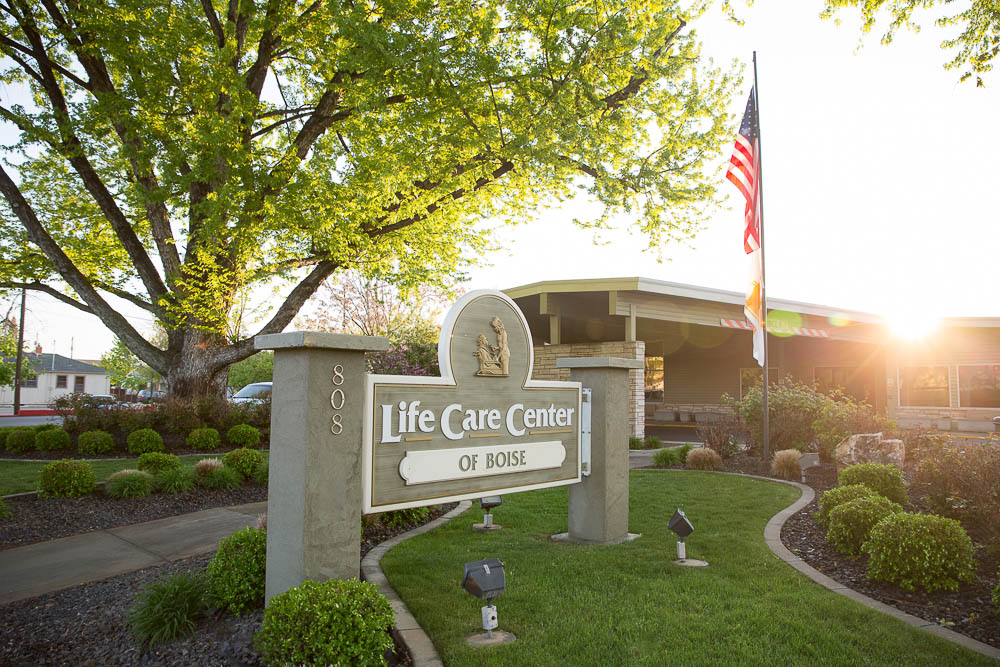 Sign for Life Care Center of Boise with plants and building behind