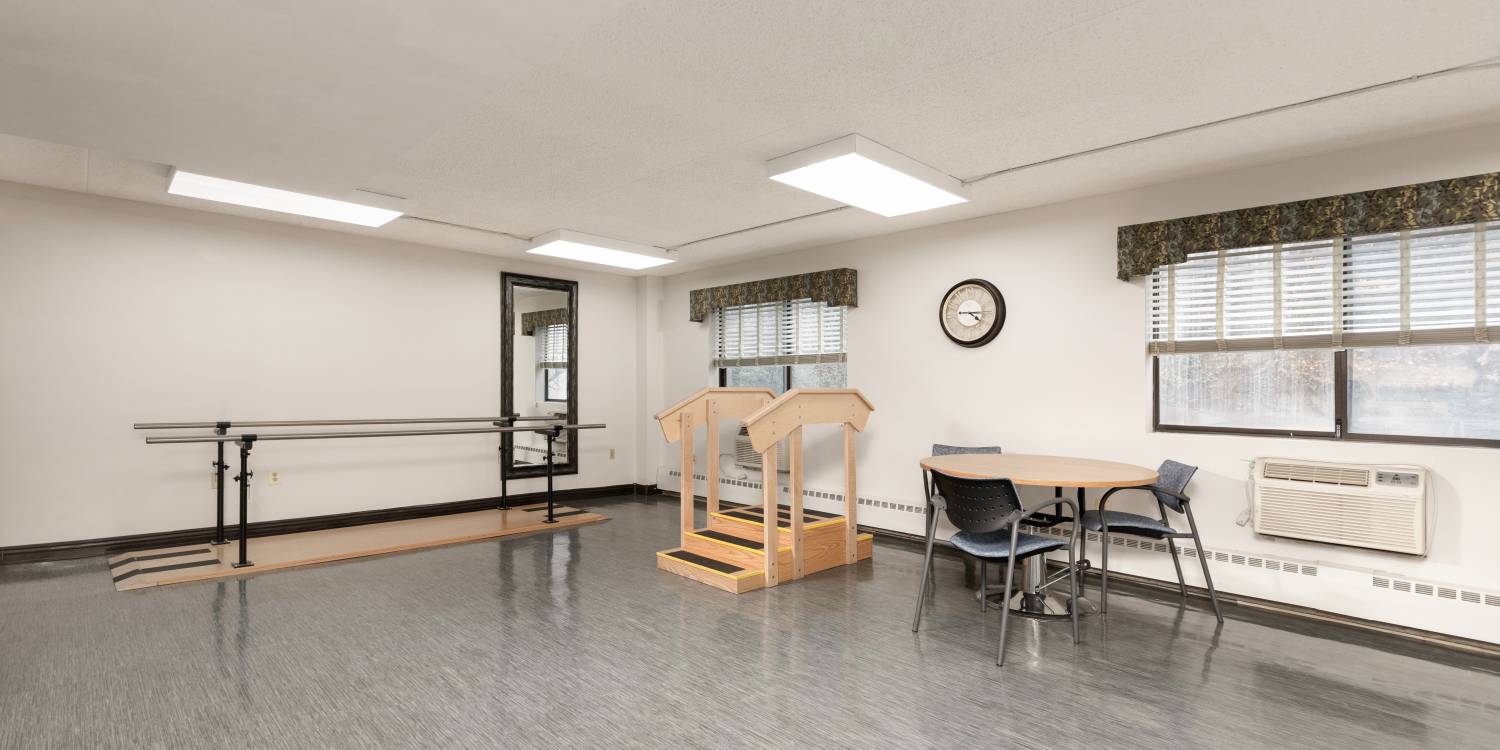 Physical therapy room with equipment and seating