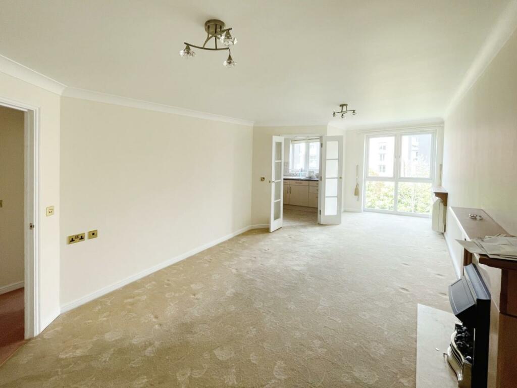 Bright empty living room with large windows