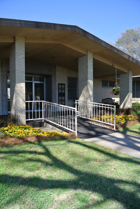 Accessible entrance with flowers and landscaping