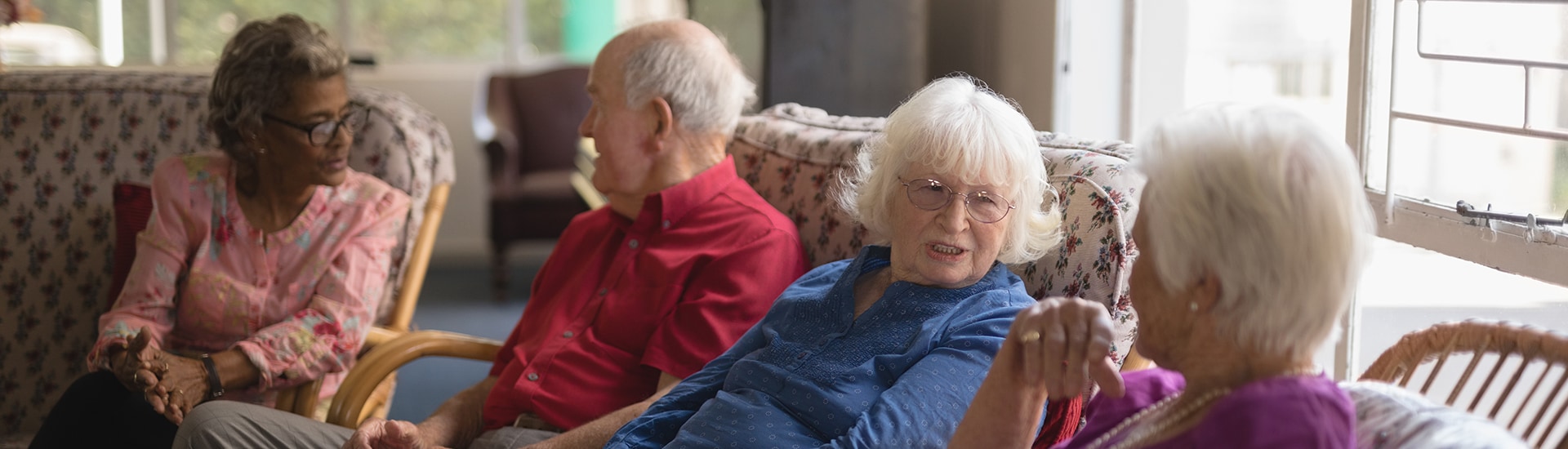 Residents engaging in conversation in a common area.