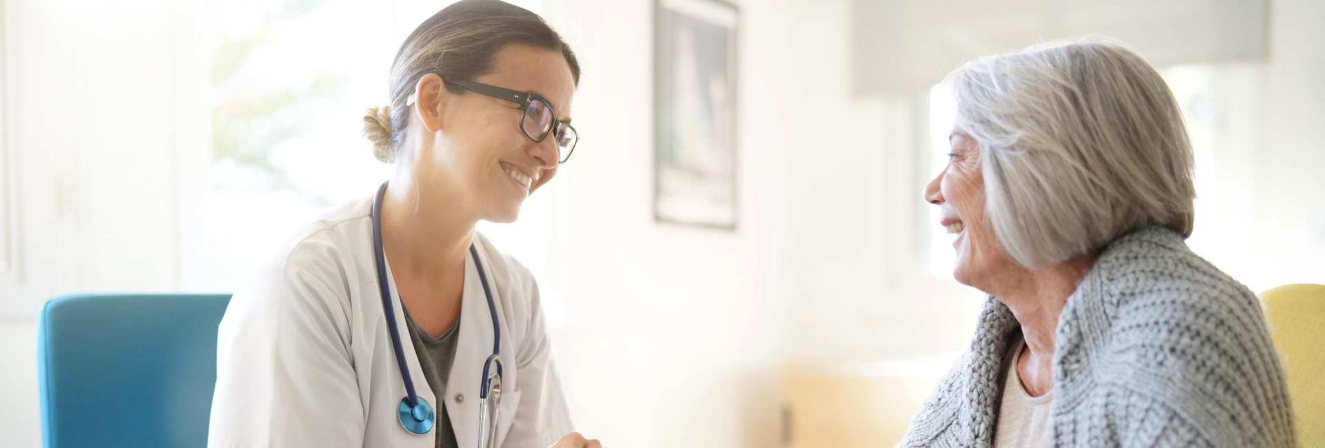 Healthcare professional interacting with a senior resident.