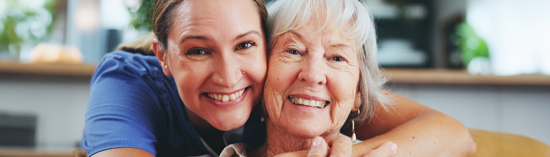 Staff member and resident smiling together.