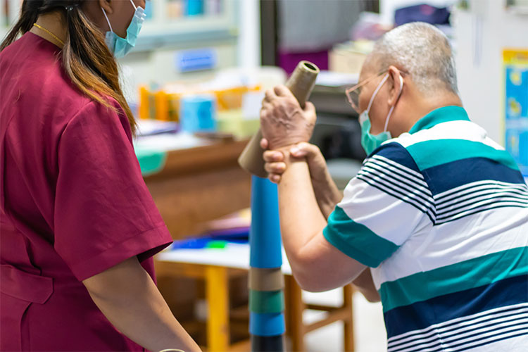 Staff assisting a resident with an activity