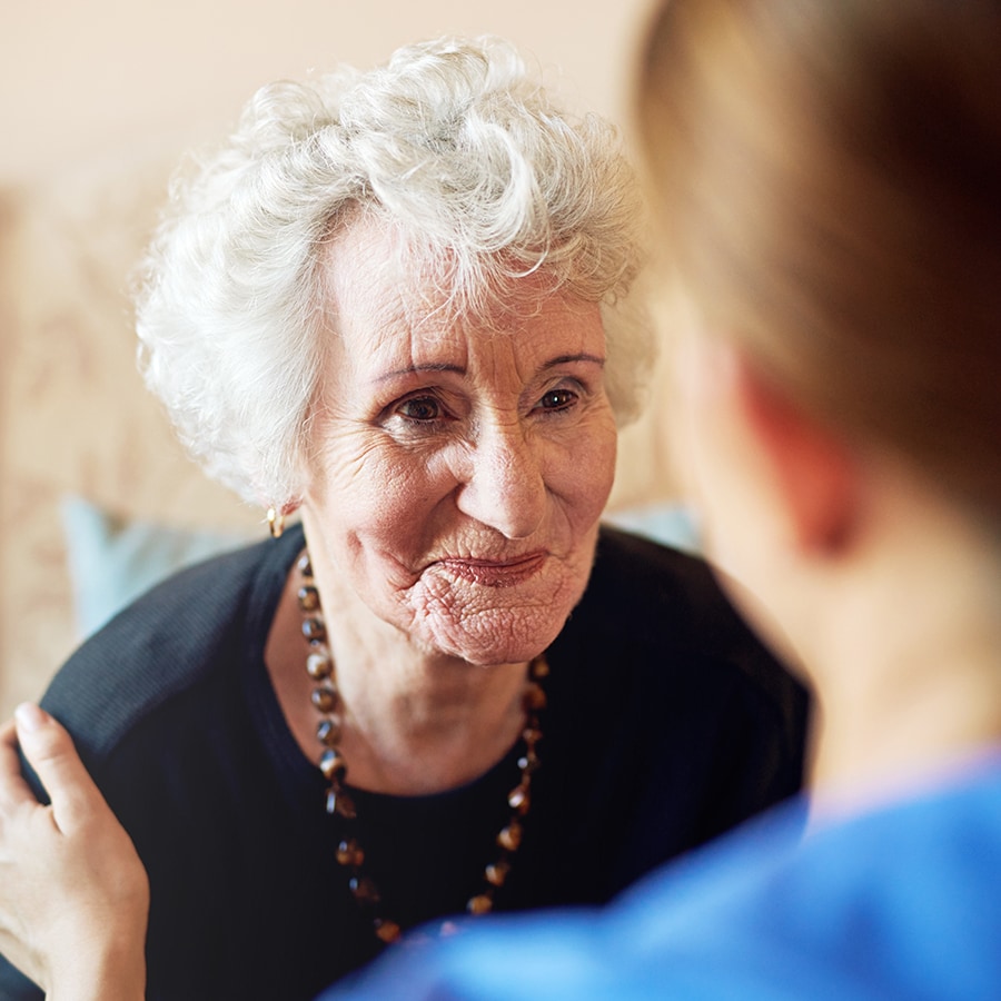 Senior resident smiling with caregiver interaction