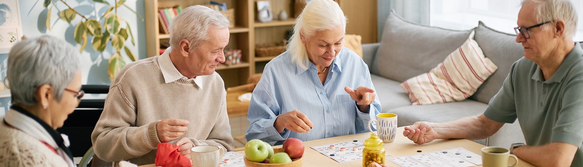 Seniors enjoying a game around a table